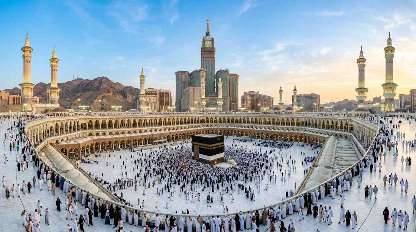 Panoramic view of Masjid al-Haram at sunrise with the Kaaba and Clock Tower.